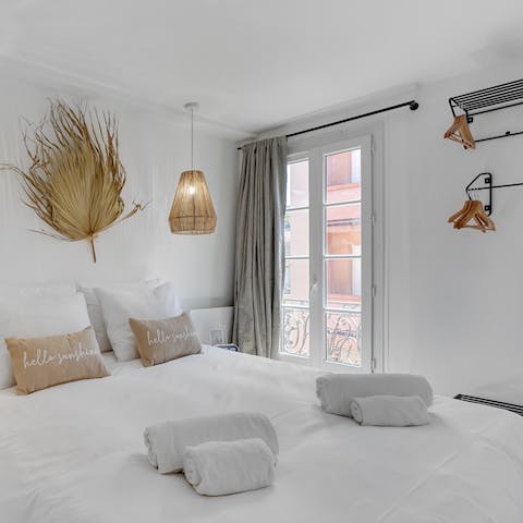 Wake up after a restful sleep to your bright bedroom, opening the windows to watch the world go by below