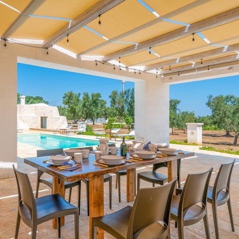 Dine alfresco on the shaded terrace by the pool