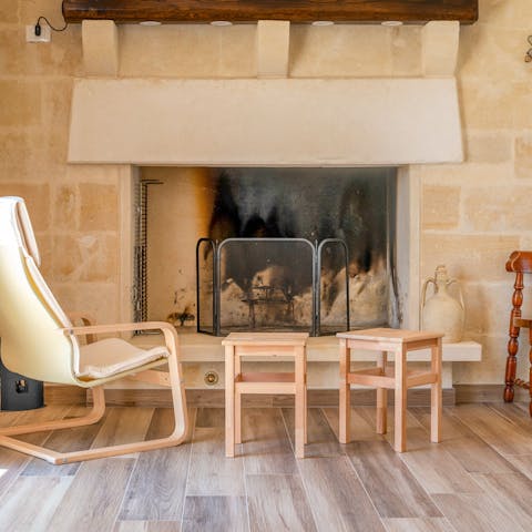 Sit by the fireplace on a cosy evening as the fireplace roars