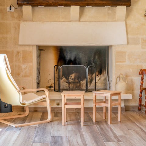 Sit by the fireplace on a cosy evening as the fireplace roars