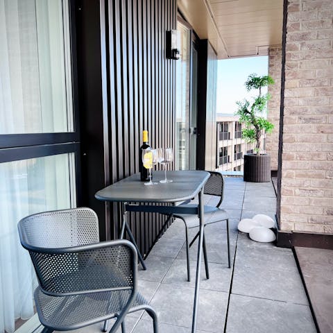 Unwind on the balcony with a glass of wine