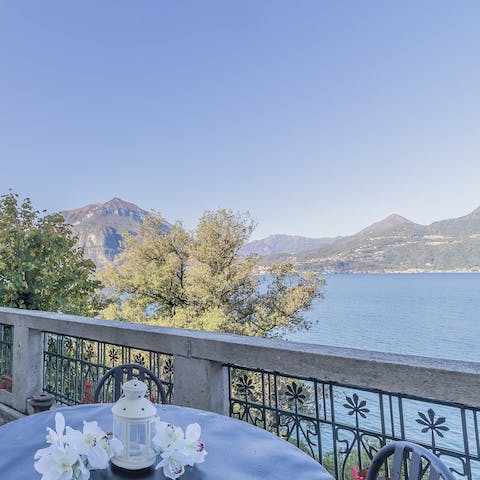 Gaze out over Lake Como flanked by mountains from the balcony