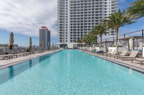 Swim laps in the shared pool high above the Hollywood skyline