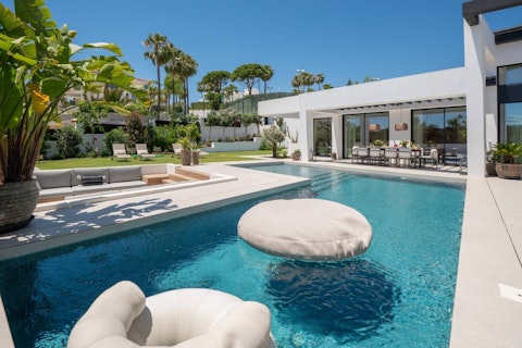 Float in the private pool beneath clear Marbella skies