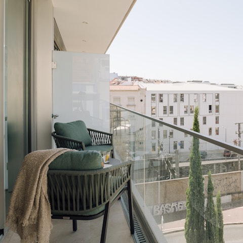 Toast the day's end from the private balcony