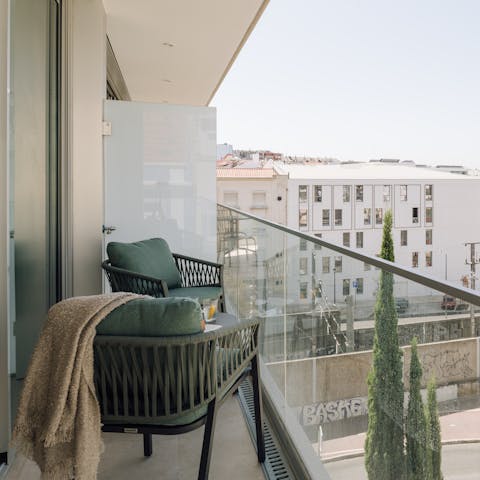 Toast the day's end from the private balcony