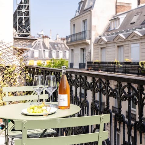 Enjoy a glass of wine on the balcony with views across the Parisian rooftops