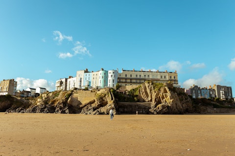 Swim or sunbathe on Castle Beach, framed by Tenby's medieval castle ruins, a twenty-minute drive