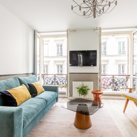 Indulge in some people-watching from the living room's Juliet balconies, a cup of coffee in hand