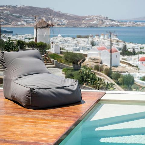 Relax on the day bed while taking in views over the Mykonos rooftops