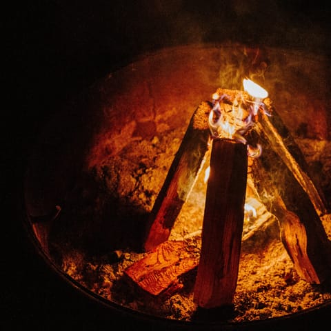 Gather around the campfire area in the woods – perfect for toasting marshmallows
