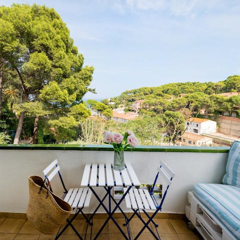 Retreat to the balcony with an elevated view over the Mediterranean coastline