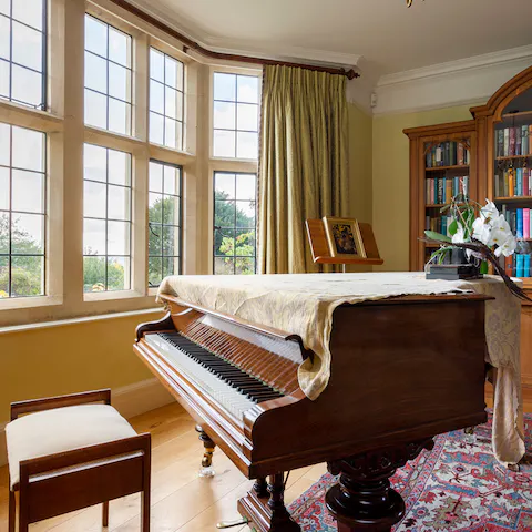 Engage in old-fashioned entertainment, singing at the piano and playing charades