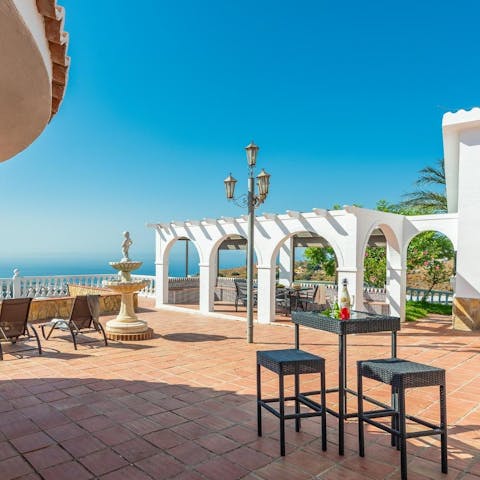 Share a bottle of wine and watch the sunset from the terrace