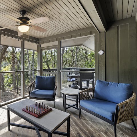 Relax on the screened porch, overlooking the coastal forest and lagoon