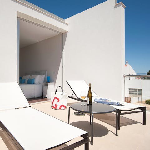 Watch the sunset with a drink on the first-floor balcony