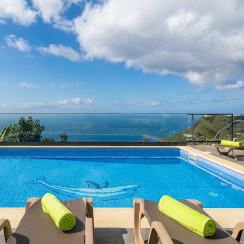Enjoy a refreshing dip in the outdoor pool while admiring the views