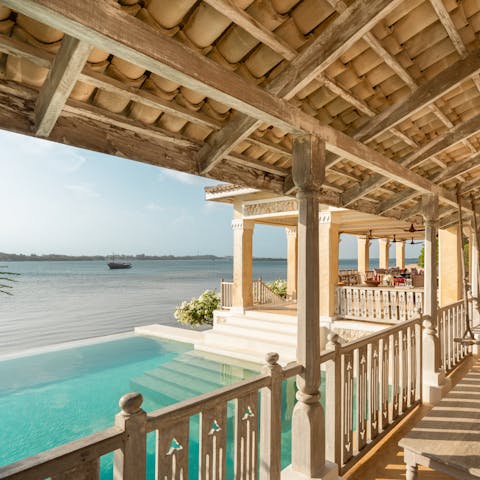 Admire views of the Mkanda Channel as you swim in the private pool