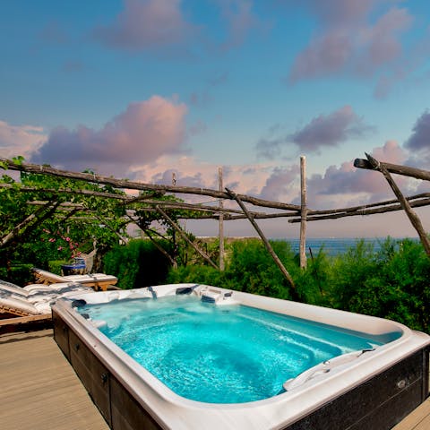 Unwind in the hot tub with a glass of wine