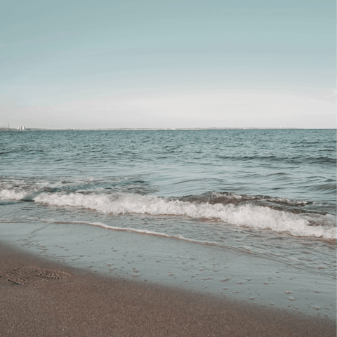 Sunbathe on Psarou Beach – it's an eight-minute drive