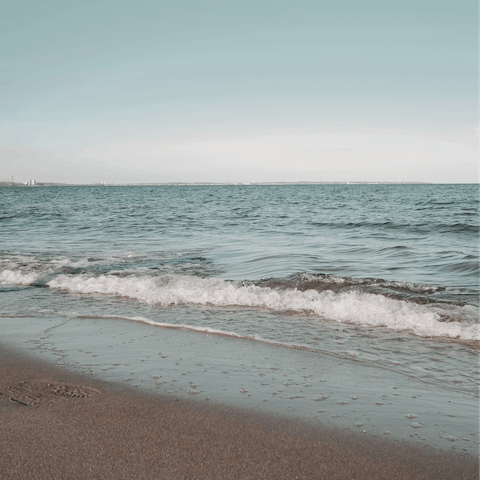 Sunbathe on Psarou Beach – it's an eight-minute drive