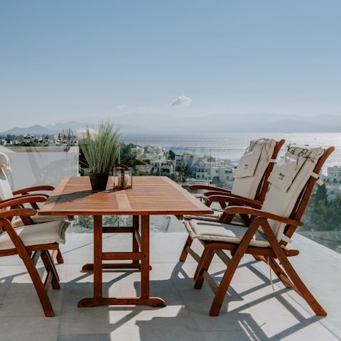 Dine on the balcony with stunning views of the Aegean