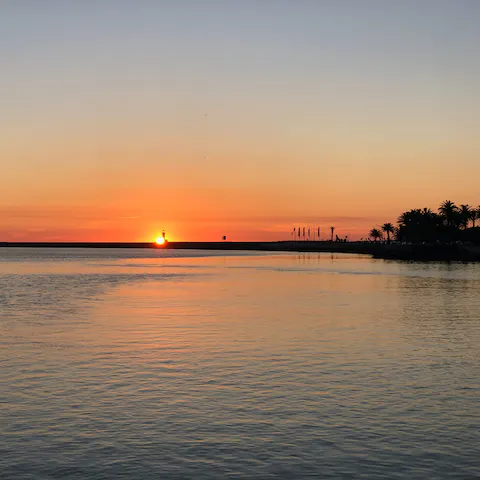 Watch the sunset at Praia do Túnel beach, only a twenty–two–minute walk away