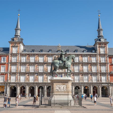 People watch from a cafe in the bustling Plaza Mayor