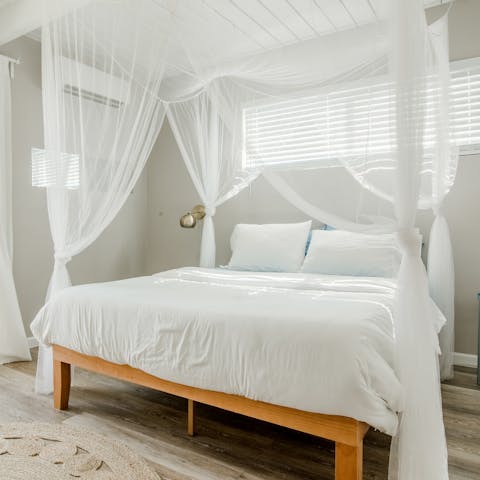 Wake up to the dreamy drapes of the four-poster bed