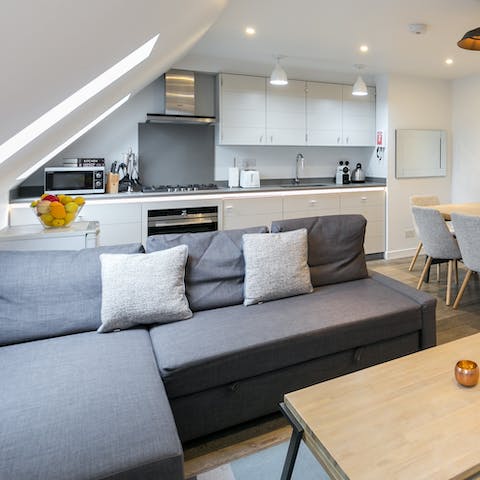 Relish the sunlight pouring in through the slanted windows as you relax on the sofa with a glass of wine