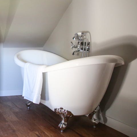 Relax in the deep clawfoot bathtub