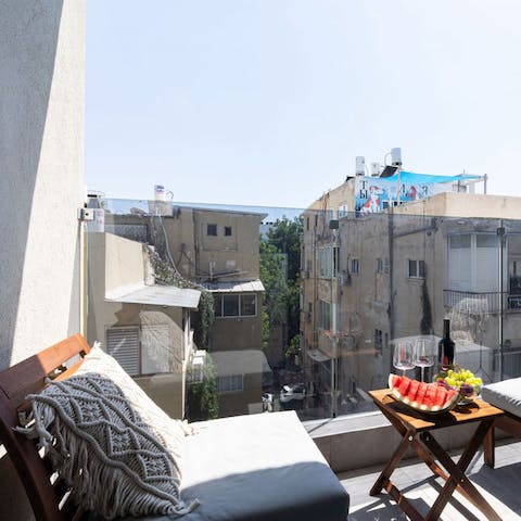 Sip on a bottle of wine on the balcony