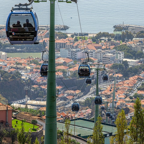 Ride the cable car in Funchal, less than a thirty-minute drive away