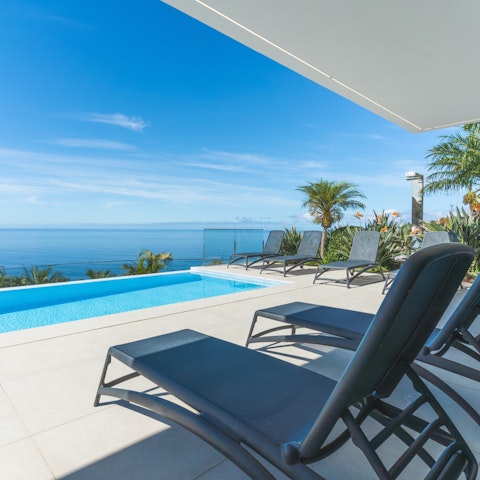 Savour sea views as you relax on the poolside
