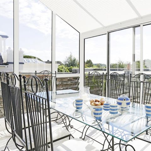 Pour your tea and butter your toast for breakfast in the conservatory