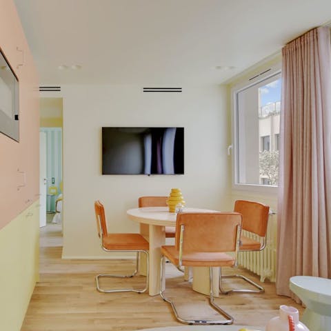 Begin your day with croissants in the candy-coloured living and dining space