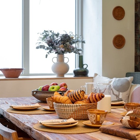 Tuck into fresh pastries from the boulangerie at the rustic dining table