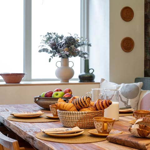 Tuck into fresh pastries from the boulangerie at the rustic dining table