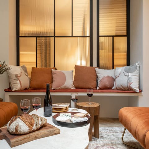 Relax on the sofa with a bottle of red and a selection of French cheeses