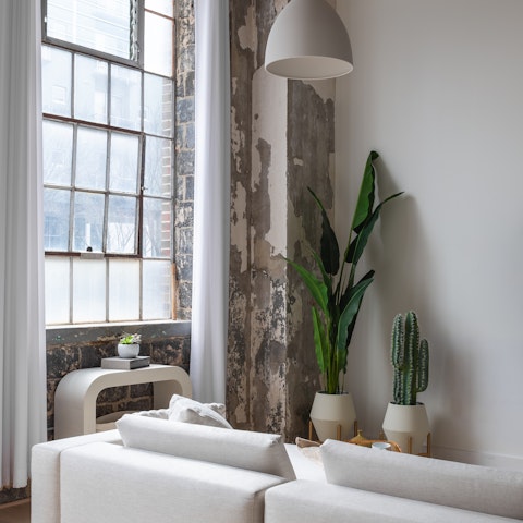 Read your favourite novel on the sofa by the enormous windows