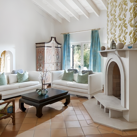 Gather in the living area by the fireplace for a relaxing evening