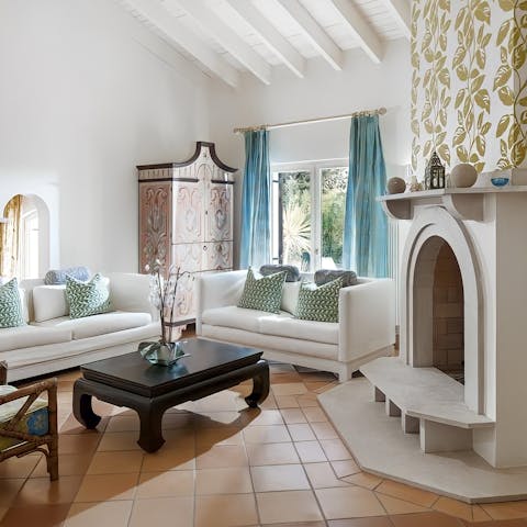 Gather in the living area by the fireplace for a relaxing evening