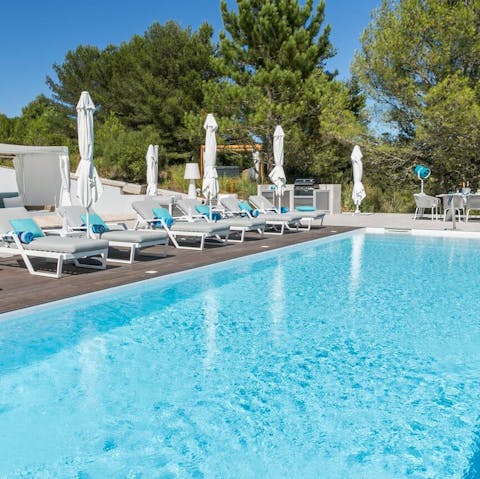 Lie out by the crystalline swimming pool