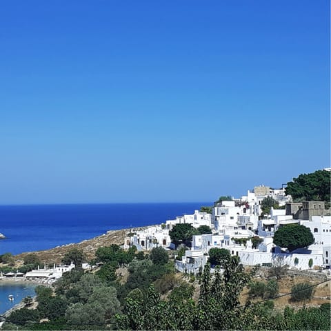 Explore Lindos and its clifftop acropolis, ten minutes away by car