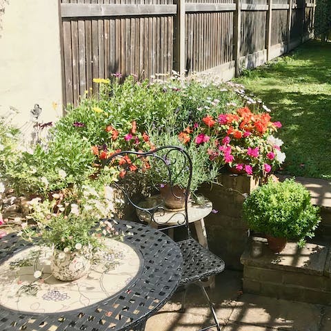 Enjoy your coffee with the morning sun on your face beside the roses