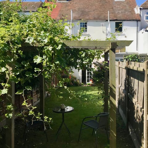 Catch up on a good book beneath the vine woven pergola