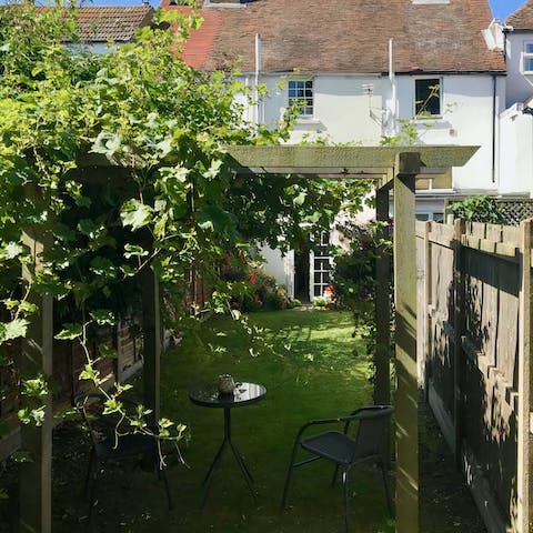 Catch up on a good book beneath the vine woven pergola