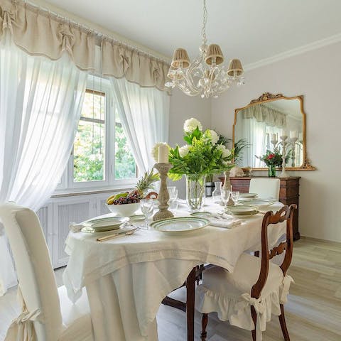 Gather together for an elegant dinner in the antique-laden dining room