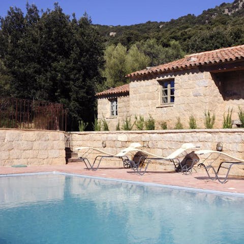 Laze on loungers in the sun before cooling off with a refreshing dip in the outdoor pool