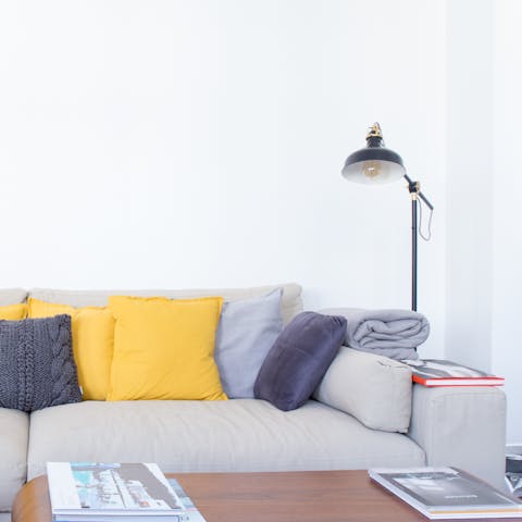 Curl up under a blanket on the large sofa after a long day exploring Berlin